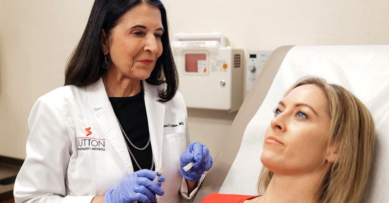 Dr. Margaret Sutton performing procedure on patient lying down in recliner