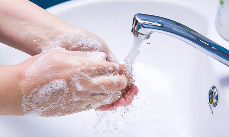 Washing hands under sink