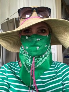 Woman wearing bandanna and vacation hat with sunglasses