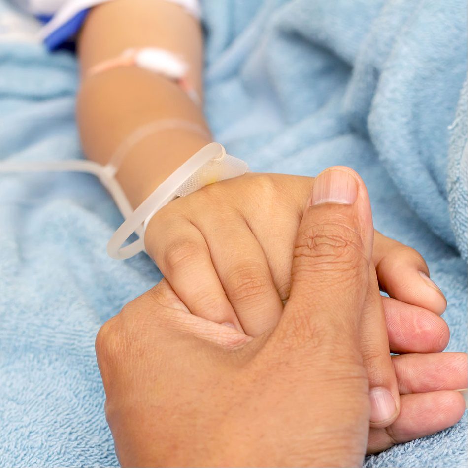 Patient's hand being held by another hand