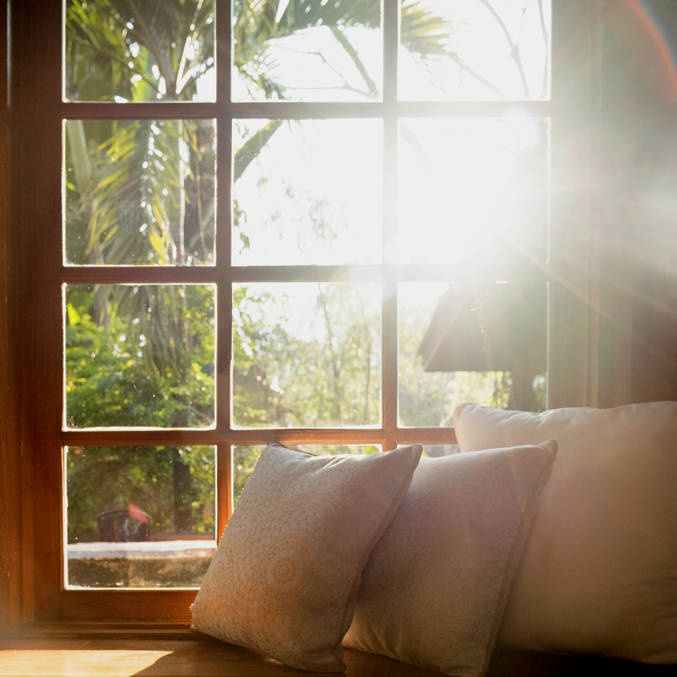 window sill with pillows sun light flooding in