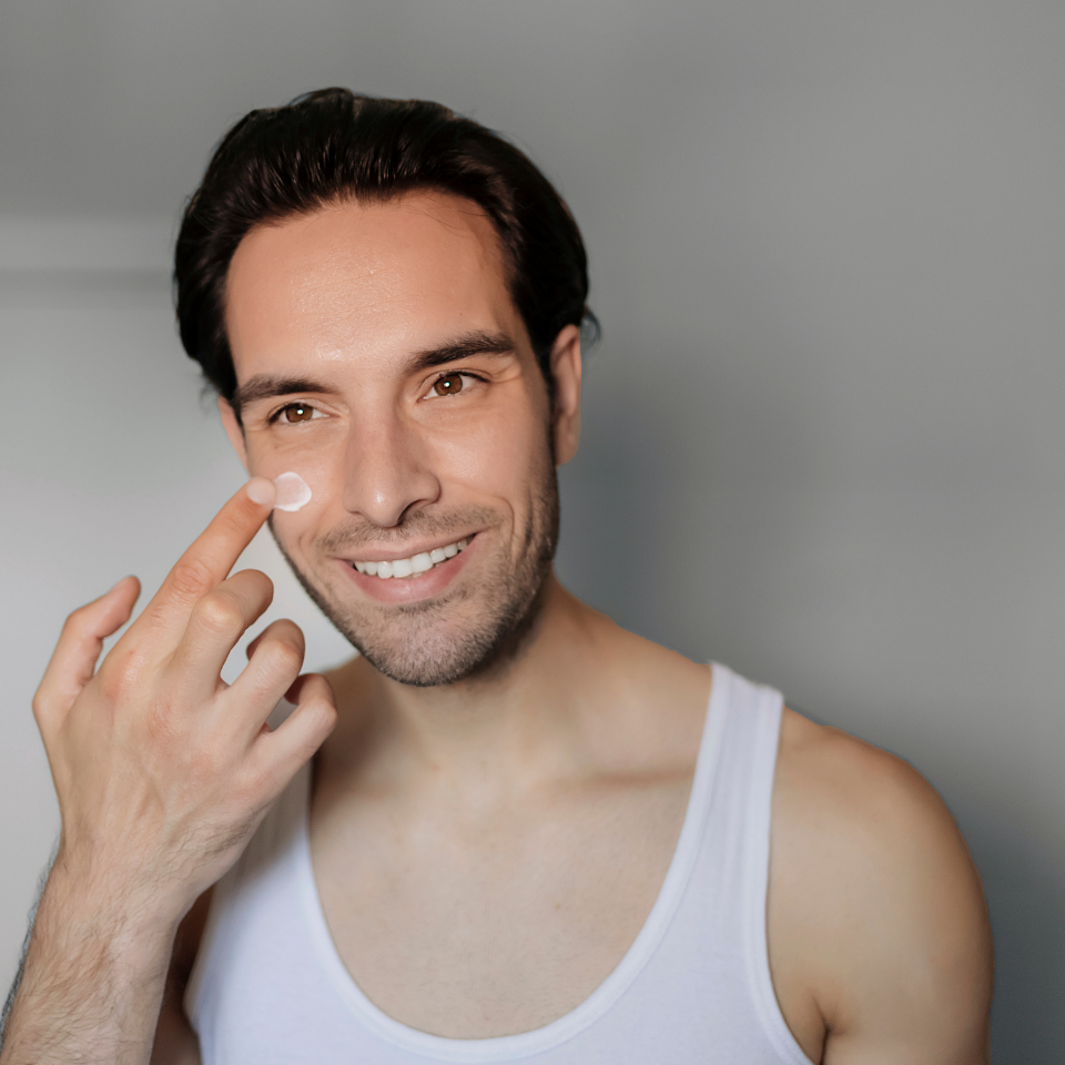 man putting on face cream