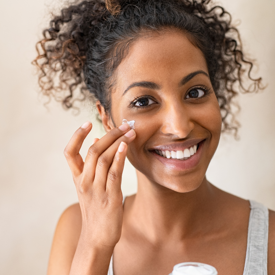 woman putting on face cream