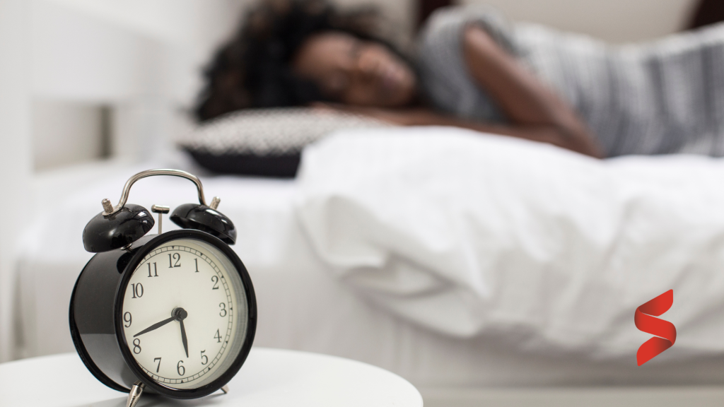 Alarm clock and sleeping woman with sutton logo