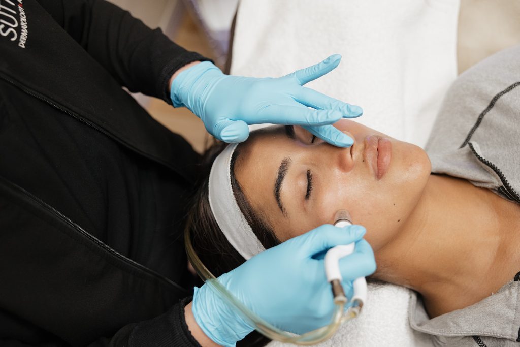 Provider Meghan Richards applying DiamondGlow Facial treatment to patient