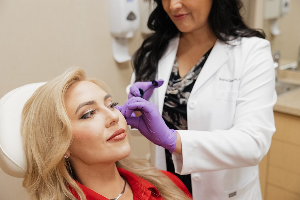 Provider Sharon Spethman applying fillers to patient's face