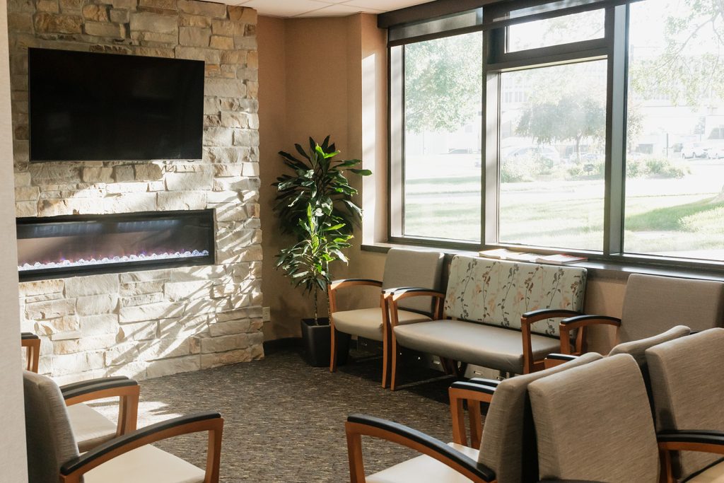 Waiting area with TV and comfortable chairs at L Street Clinic at Sutton Dermatology + Aesthetics