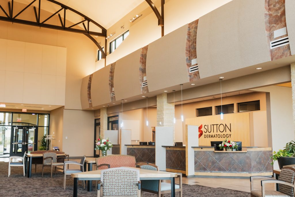 Interior building image showing large waiting room and reception area with natural light at South Clinic Sutton Dermatology + Aesthetics