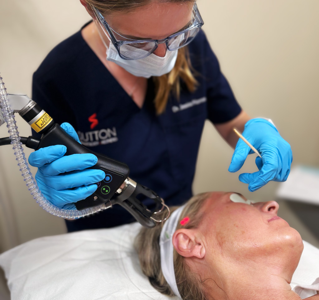 Sutton Dermatology and Aesthetics provider using the CoolPeel machine on a patient's face