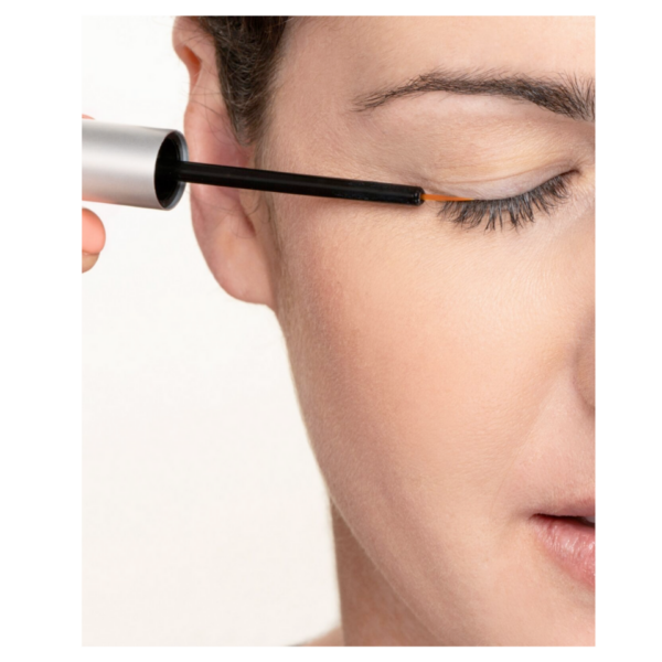woman putting Nu-Cil on eyelash line