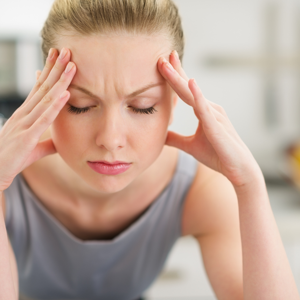 woman looking stressed with hands on face