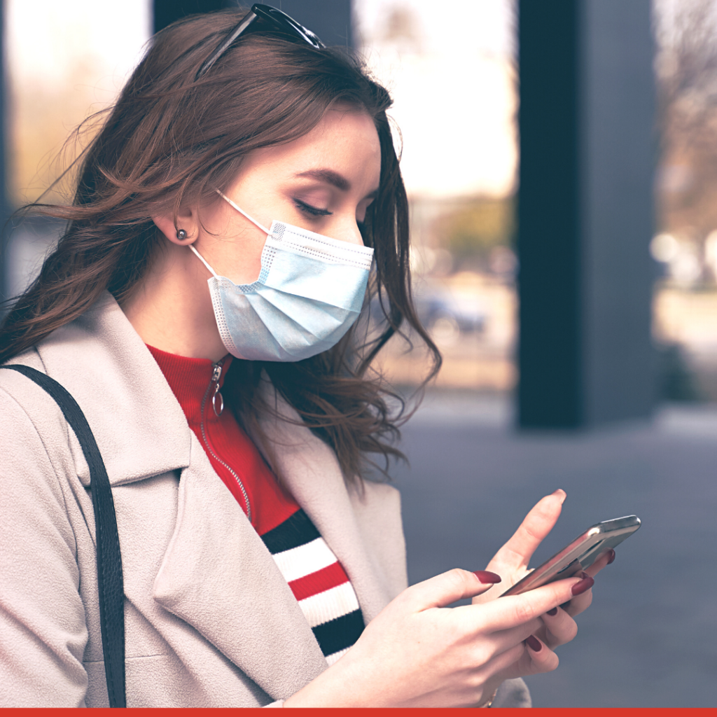 woman with medical mask, working on cell phone